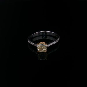 750 white and yellow gold ring with a 1.05 ct Fancy Light Yellow cushion-cut diamond and F/VVS diamonds.