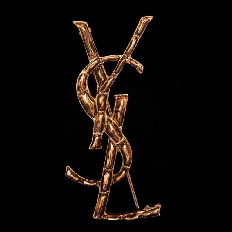Gold-tone Saint Laurent YSL brooch in brass with crocodile-skin imitation texture