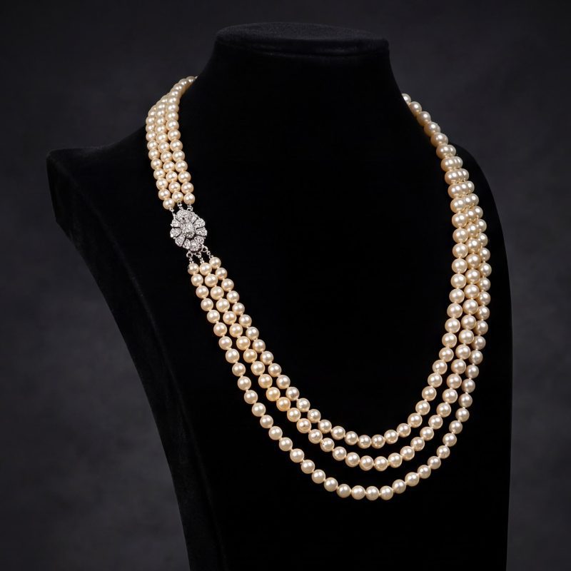 Three-strand Akoya pearl necklace from the first half of the 20th century with a platinum clasp set with approximately 1.16 ct of antique-cut diamonds.