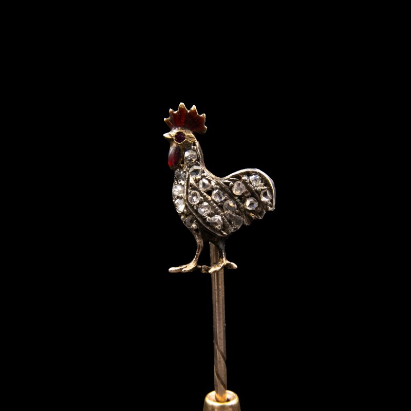 19th-century British stick pin featuring a rooster decorated with antique-cut diamonds, a ruby and red enamel.